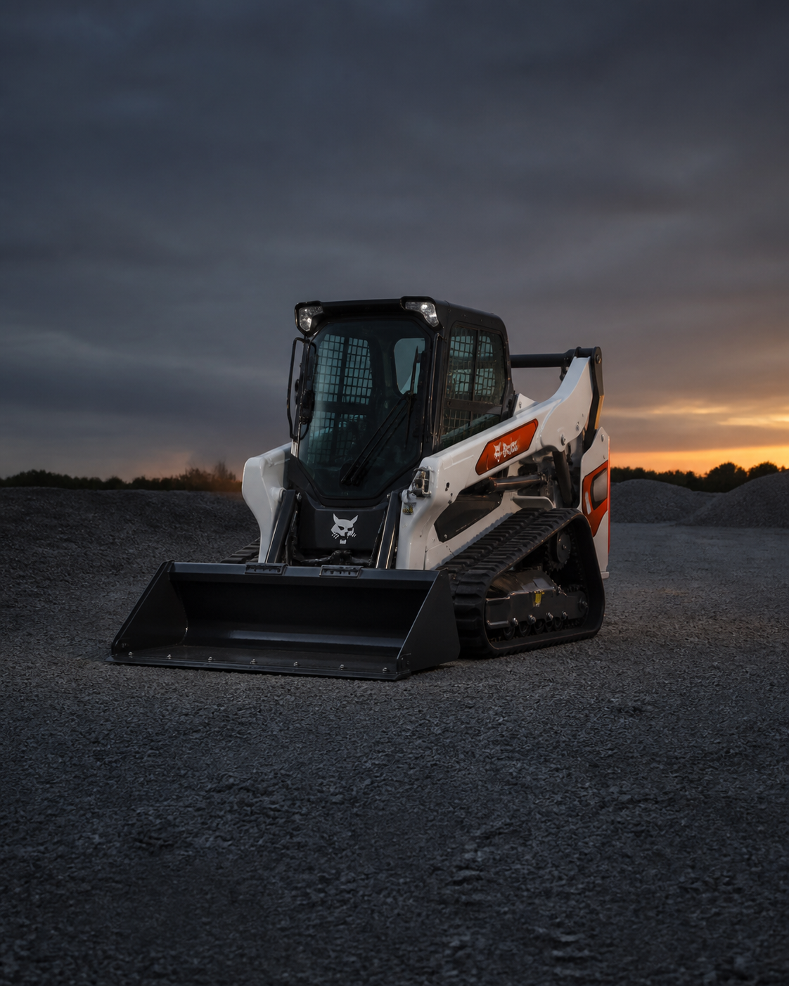 Bobcat compact track loader centered in an industrial equipment yard