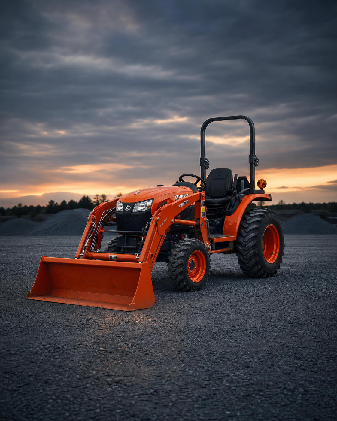 Kubota compact tractor with front loader centered in an industrial yard