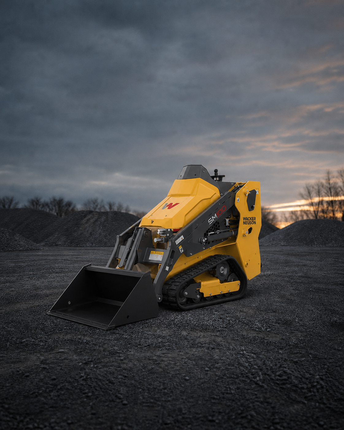 Wacker Neuson mini skid steer centered in an industrial equipment yard